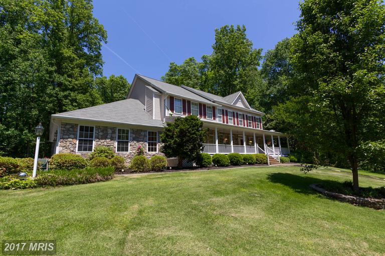 Gorgeous one of a kind home on cul de sac backing to acres of woods with rambling stream.